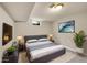 A finished basement bedroom with carpet floors, lamps, and dresser at 6990 Larsh Dr, Denver, CO 80221
