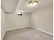 Open basement space with carpet floors and small windows; ready for customization at 6990 Larsh Dr, Denver, CO 80221