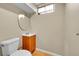 Well-lit bathroom featuring a new vanity, toilet and small window at 6990 Larsh Dr, Denver, CO 80221