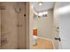 Modern bathroom featuring a tiled walk-in shower with rainfall shower head and glass door at 6990 Larsh Dr, Denver, CO 80221
