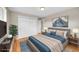 Comfortable bedroom features a plush bed, stylish decor, and a spacious closet for ample storage at 6990 Larsh Dr, Denver, CO 80221