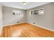 This spacious bedroom offers natural light and stunning hardwood floors at 6990 Larsh Dr, Denver, CO 80221