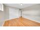 A bright bedroom features hardwood floors and a closet with sliding doors at 6990 Larsh Dr, Denver, CO 80221