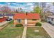 An aerial view shows a well-maintained home with a landscaped front yard and driveway at 6990 Larsh Dr, Denver, CO 80221