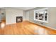 Bright living room features hardwood floors, a fireplace, and a large bay window at 6990 Larsh Dr, Denver, CO 80221