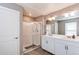 Bright bathroom featuring a glass shower, double vanity, and modern fixtures at 13921 Scarlet Sage Ln, Parker, CO 80134