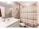 Clean bathroom featuring a shower with a patterned curtain and stylish decor at 13921 Scarlet Sage Ln, Parker, CO 80134