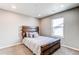 Comfortable bedroom showcasing a modern wood frame bed and natural light at 13921 Scarlet Sage Ln, Parker, CO 80134