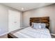 Cozy bedroom with a wood headboard, neutral colors, and ample closet space at 13921 Scarlet Sage Ln, Parker, CO 80134