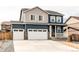 Beautiful two-story home with a three-car garage, stone accents, and covered front porch at 13921 Scarlet Sage Ln, Parker, CO 80134