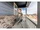 Relaxing front porch with a porch swing and stone accents at 13921 Scarlet Sage Ln, Parker, CO 80134