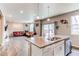 Open-concept kitchen overlooking living area with stainless steel appliances and modern finishes at 13921 Scarlet Sage Ln, Parker, CO 80134