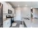 Modern kitchen featuring stainless steel appliances, gray countertops, and white cabinetry at 13921 Scarlet Sage Ln, Parker, CO 80134