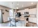 Stylish kitchen with white cabinets, stainless steel appliances, and an island with seating at 13921 Scarlet Sage Ln, Parker, CO 80134