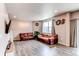 Open living room with hardwood floors, large windows, and comfortable seating at 13921 Scarlet Sage Ln, Parker, CO 80134