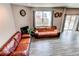 Spacious living room featuring hardwood floors and comfortable seating, with plenty of natural light at 13921 Scarlet Sage Ln, Parker, CO 80134