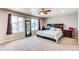 Spacious main bedroom featuring a ceiling fan, and a large window for ample light at 13921 Scarlet Sage Ln, Parker, CO 80134