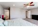 Spacious main bedroom with a ceiling fan and doors leading to other rooms at 13921 Scarlet Sage Ln, Parker, CO 80134