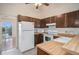 Charming kitchen with white appliances, wood cabinets, and a sliding door to the balcony at 9612 W Chatfield Ave # C, Littleton, CO 80128