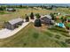 Expansive aerial view showcasing a home with detached garage and well-manicured lawn at 8682 N Sundown Trl, Parker, CO 80134