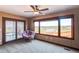 Bright bedroom with large windows and a seating area overlooking a scenic landscape at 8682 N Sundown Trl, Parker, CO 80134