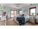Inviting bedroom with a bed, a door leading to a balcony, and a large window overlooking a view at 8682 N Sundown Trl, Parker, CO 80134