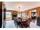 Elegant dining room featuring a large table, chandelier, fireplace, and outdoor views at 8682 N Sundown Trl, Parker, CO 80134