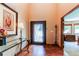 Elegant home foyer with hardwood floors, stylish console table, and decorative front door at 8682 N Sundown Trl, Parker, CO 80134