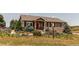 Charming single-Gathering home with a landscaped front yard featuring colorful flowers and lush greenery at 8682 N Sundown Trl, Parker, CO 80134