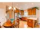 Sunlit kitchen featuring stainless steel appliances, custom cabinetry, and an adjacent dining area at 8682 N Sundown Trl, Parker, CO 80134