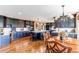 Kitchen and dining area boasts dark cabinets, island seating, stainless appliances, and hardwood floors at 8682 N Sundown Trl, Parker, CO 80134