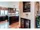 Gourmet kitchen featuring dark wood cabinetry, wine fridge, quartz counters, and modern fixtures at 8682 N Sundown Trl, Parker, CO 80134