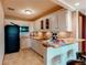 Well-equipped kitchenette with white cabinetry, modern appliances, and a convenient breakfast bar at 8682 N Sundown Trl, Parker, CO 80134