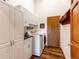 Functional laundry room with modern washer/dryer, white cabinets, and ample storage space at 8682 N Sundown Trl, Parker, CO 80134