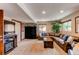 Spacious living room with a comfortable leather sectional sofa, fireplace, and ample lighting at 8682 N Sundown Trl, Parker, CO 80134