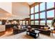 Spacious living room with floor-to-ceiling windows offering panoramic views and open concept floorplan at 8682 N Sundown Trl, Parker, CO 80134