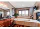 Elegant main bathroom with a large tub, tile surround, and a cozy fireplace nearby at 8682 N Sundown Trl, Parker, CO 80134