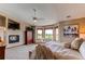 Cozy main bedroom with fireplace, sitting area, and large windows offering natural light and outdoor views at 8682 N Sundown Trl, Parker, CO 80134
