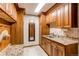 Well-organized mud room with granite counters, tile floor, cabinets, and hooks for storage at 8682 N Sundown Trl, Parker, CO 80134