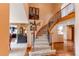 Grand staircase with wood and iron railing, carpeted steps, and elegant decor throughout at 8682 N Sundown Trl, Parker, CO 80134