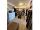 Bright walk-in closet with built-in shelving and a central ottoman for added convenience at 8682 N Sundown Trl, Parker, CO 80134