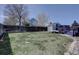A full backyard, with a wooden fence, deck, above ground pool, and well-kept lawn at 4361 Kirk Ct, Denver, CO 80249