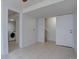 Basement featuring tile floors, a laundry area, and a staircase at 4361 Kirk Ct, Denver, CO 80249