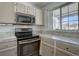 Close up of the stove and cabinets in the kitchen of the house at 4361 Kirk Ct, Denver, CO 80249