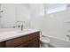 Bathroom features a vanity with a white countertop, a toilet, and a shower-tub combo at 6653 Bridlespur St, Castle Pines, CO 80108