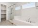 Bathroom featuring a large, glass enclosed shower and soaking tub with tile surround at 6653 Bridlespur St, Castle Pines, CO 80108