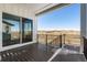 Spacious outdoor deck overlooking beautiful landscape with stairs leading to yard at 6653 Bridlespur St, Castle Pines, CO 80108