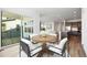 Bright dining area with wood flooring adjoins the living room and kitchen for easy access at 6653 Bridlespur St, Castle Pines, CO 80108