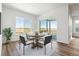 Bright dining area with wood flooring and an outdoor view at 6653 Bridlespur St, Castle Pines, CO 80108