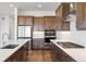 Bright kitchen showcasing stainless steel appliances, custom cabinets, and expansive countertops at 6653 Bridlespur St, Castle Pines, CO 80108